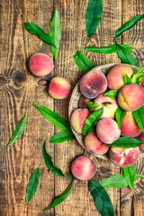 Ripe juicy peaches on a rustic background