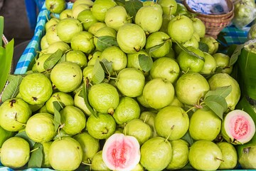 Fresh guava fruit. Green background.