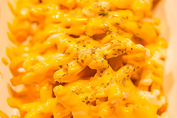 Closeup of French Fries Topped with Melted Cheddar Cheese.