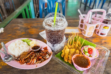 Food and drinks on wooden tables in floating markets in Thailand