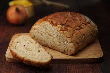 Whole wheat onion bread on wooden chop. Nutrition fact and clean food good taste ideas concept. Selective focus and free space for text.