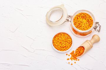 Dry orange lentils in glass jar