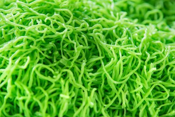 Green jade egg noodles or green noodle pattern background.