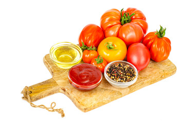 Fresh tomatoes and ketchup in glass form.