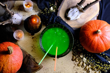 fortune-teller's table, witches covered with a black cloth, pumpkins lie, animal skulls, green...
