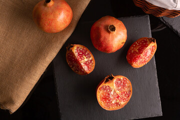 pomegranate fruit placed on a black slate