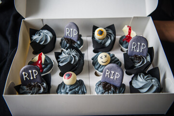 Halloween cupcakes on a dark background. Sweets for the celebration of Halloween. Halloween party.