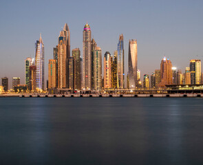 Fototapeta na wymiar View of A Dubai Marina after sunset. Shot made from Palm Jumeirah, man made island. Dubai, UAE.
