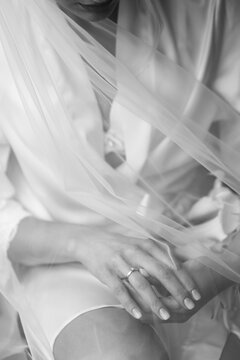 Cropped image of a charming bride adjusting her wedding ring under a veil before the ceremony.