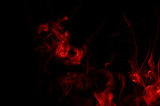 Cloud of red smoke isolated on black. movement of abstract steam.
