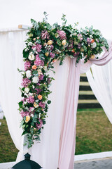 Floral details of wedding ceremony outdoors. Close up of floral bouquets and compositions.
