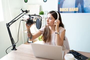 Setting up a microphone for her podcast