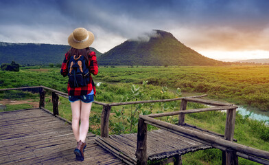 Naklejka premium Young Asian tourists stand on the viewpoint of Mount Chom Thong or Fuji Khon Buri, which is the birthplace of Moon River in Nakhon Ratchasima, Thailand.