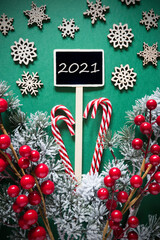 Vertical Black Sign With English Text 2021. Christmas Decoration, Like Fir Tree Branch, Candy Sticks, Snowflakes And Stars And Lights. Retro Look