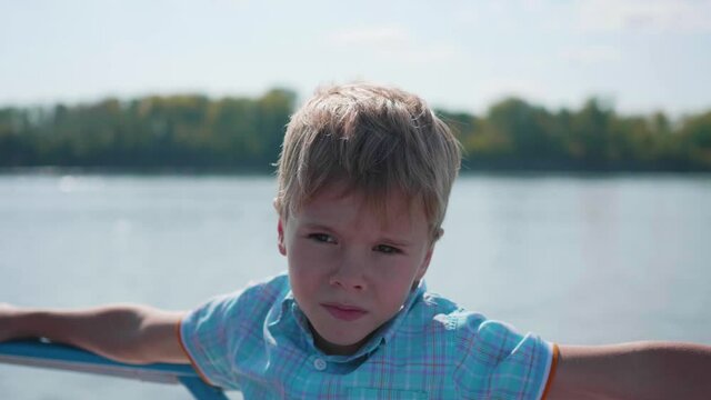 The child is sailing on the boat. Family trip