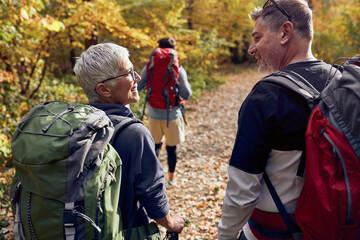 An elderly couple chatting while hiking