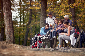 Obraz premium A happy family in love with their dog enjoying the forest together