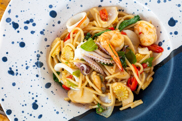 Spicy Seafood Spaghetti Dinner Dish on a the table. Traditional Spicy Spaghetti seafood with Chili & Basil. Seafood pasta Spaghetti with Clams, Prawns and Squid.