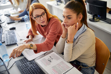 A female student worrying about hard informatics lesson. Smart young people study at the college. Education, college, university, learning and people concept