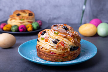 Craffin (Cruffin) with raisins, nuts and candied fruits. Easter Bread Kulich and painted eggs. Easter Holiday. Close-up.
