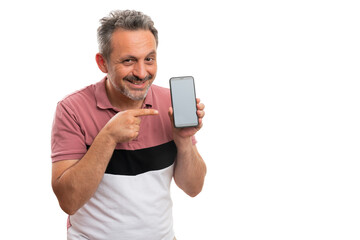 Friendly man pointing index finger at smartphone with copyspace