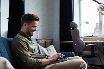 Young freelancer working in home with laptop. Texting messages, browsing internet. Studying online, online education, remote working. Young people working at home. Business concept.