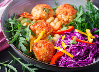 Italian pasta. Cavatappi with meatballs and salad on dark background. Dinner. Slow food concept