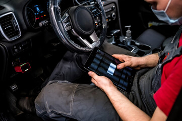 Manager hands laptop for checking the electronic systems of cars