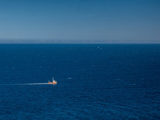 Fishing boat heading out to the ocean in the early morning