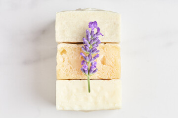 natural eco soap decorated with lavender flower on a marble background. close-up, top view