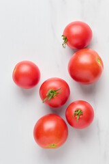ripe organic red colored tomatoes on a marble surface. flat lay, top view