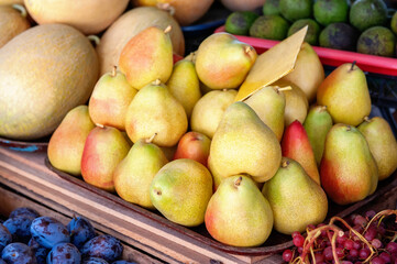 Ripe yellow pears on the market counter. the pear crop is being prepared for sale at the market. Fruit background