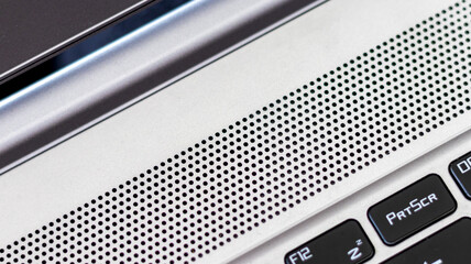 
close up grey laptop speaker, technology concept