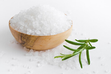 Fototapeta na wymiar Sea salt bowl and fresh rosemary twig on white table