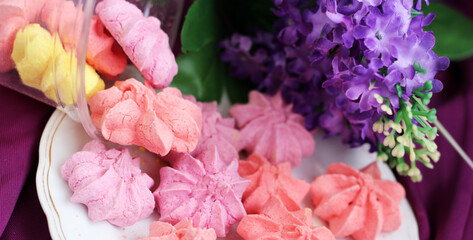 Colored meringues and purple flowers