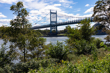 Triborough Bridge over the East River seen from the Green Randalls and Wards Islands Riverfront during Summer in New York City