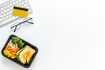 Call for delivery concept. Lunch boxes with meal on working place