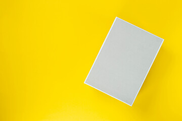 Light box on a yellow background. Space for text. Top view.