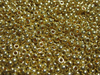 Golden glossy beads close-up.