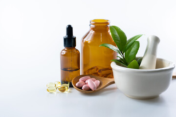 capsule and vitamin organic supplements good for health in wood spoon on white background with copy space, medicine and drug concept