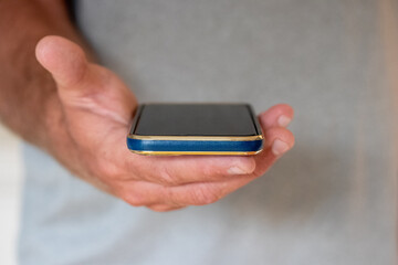 Male holding up cell phone