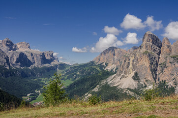 View of Sassongher mountain, 2665 m, dominates the towns of Corvara & Colfosco in Badia valley with Gardena pass on the left, seen from Piz La Ila mountain, Puez group, Dolomites, South Tirol, Italy.