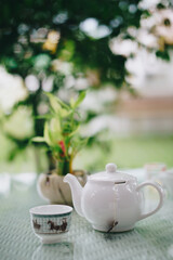 Hot Tea in White Cup on Reflective Glass Table