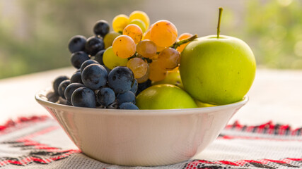 white bowl with some autumn seasonal fruits