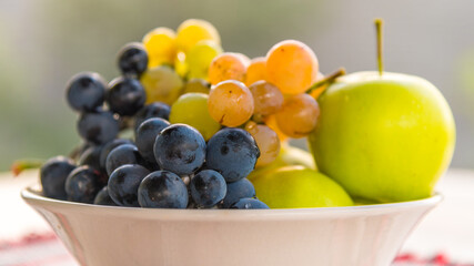 white bowl with some autumn seasonal fruits