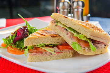 Toasts with tuna served with french fries and salad