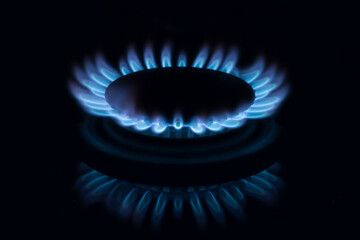 Kitchen gas burner blue gas flame with reflection