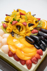 Pudding with ingredients of various colorful fruits with vitamins on a white table