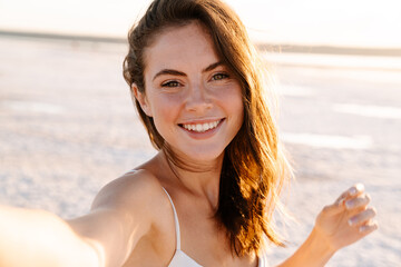 Cheery young pretty girl walking outdoors