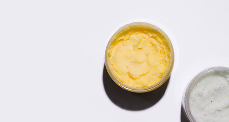 Body scrub in jars on a white background. copy space